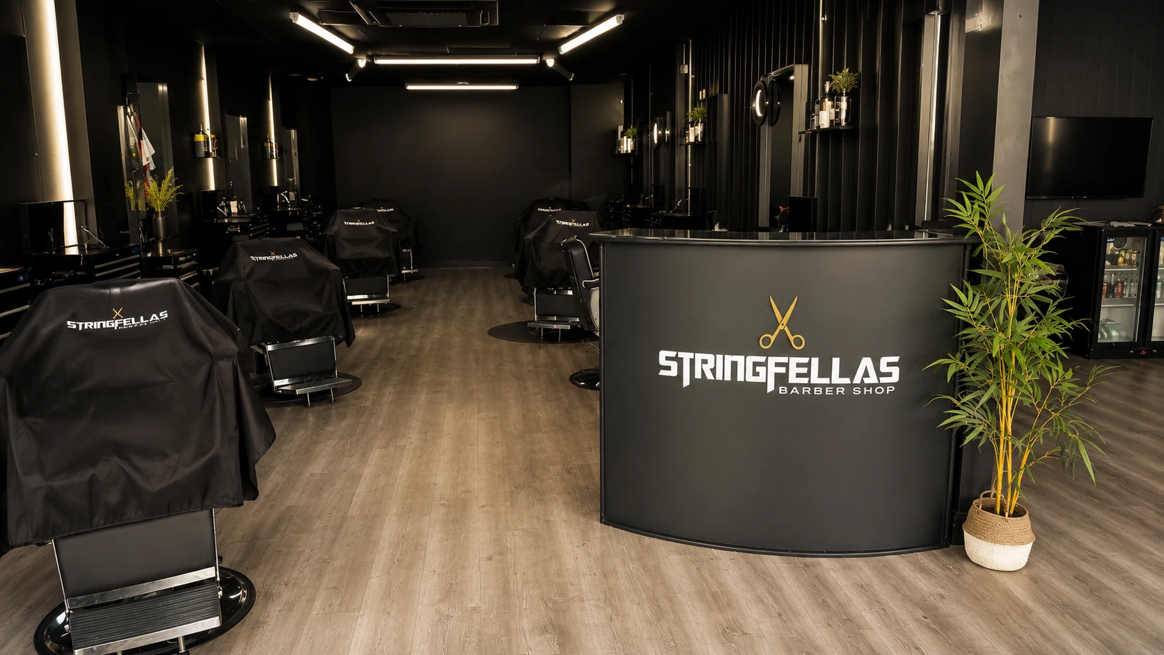 Inside Stringfellas Barber Shop in Norwich with reception desk and barber chairs